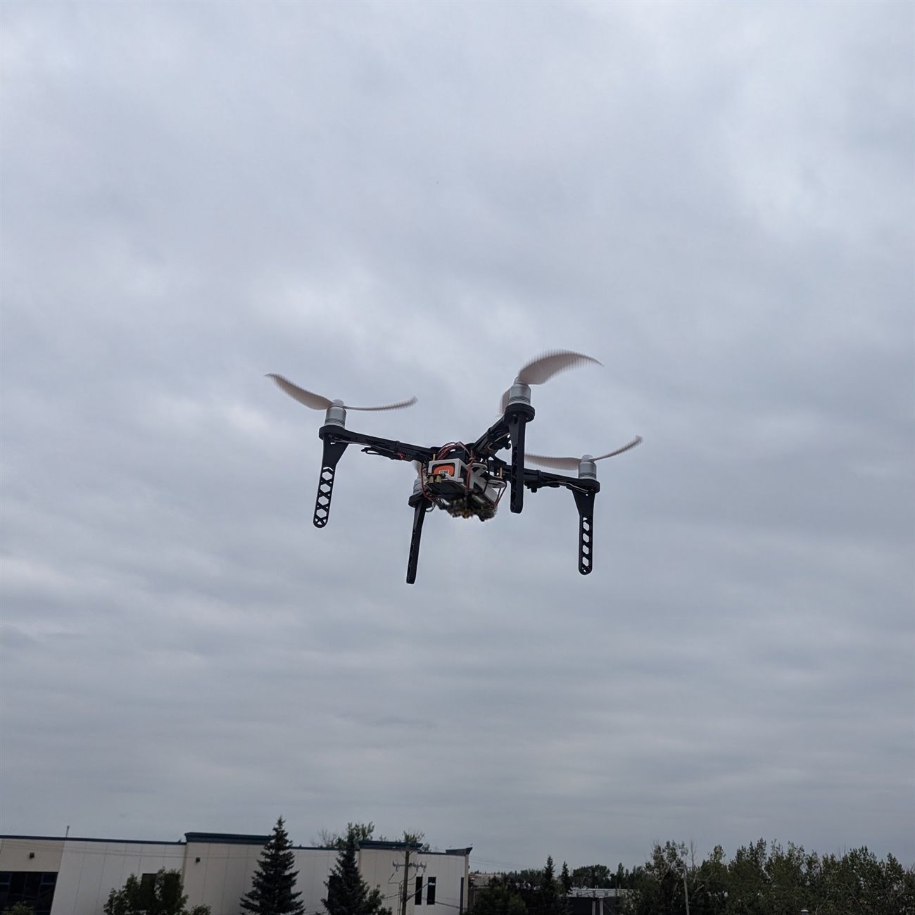 The warehouse inspection drone hover testing above a rooftop