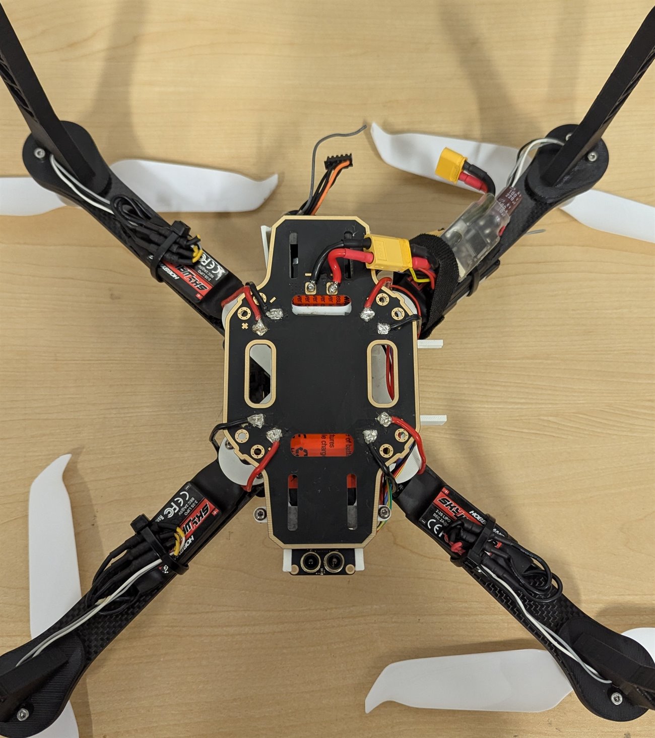 Top-down view of the drone showing the power distribution board, XT60 connector and four ESCs
