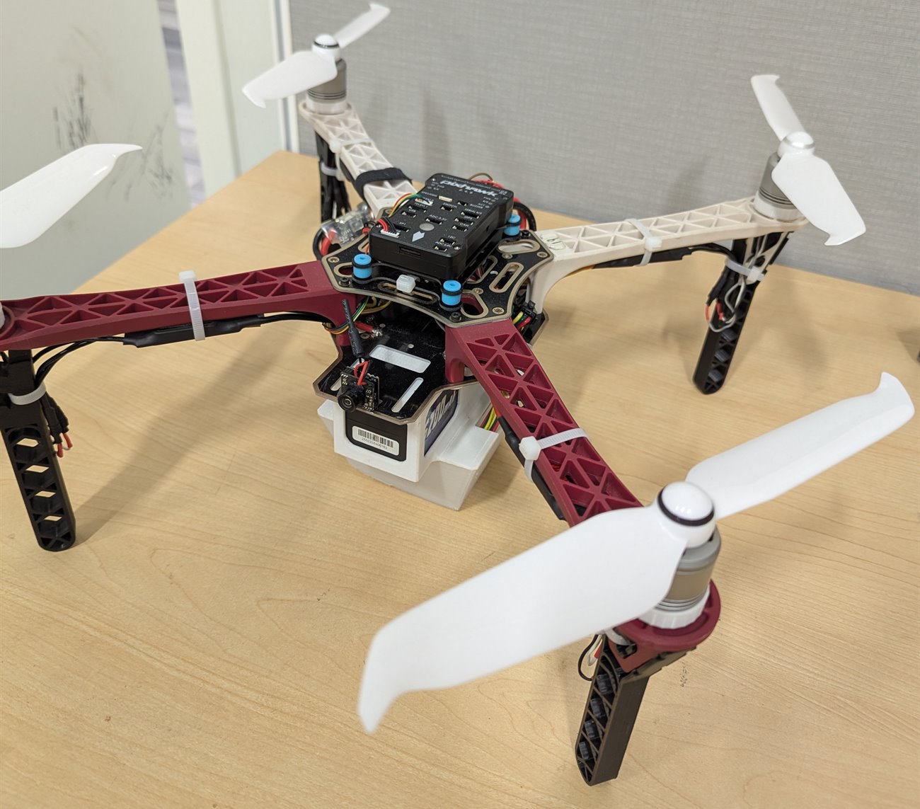 The F450 prototype quadcopter on a desk with a Pixhawk 2.4.8 flight controller mounted on top